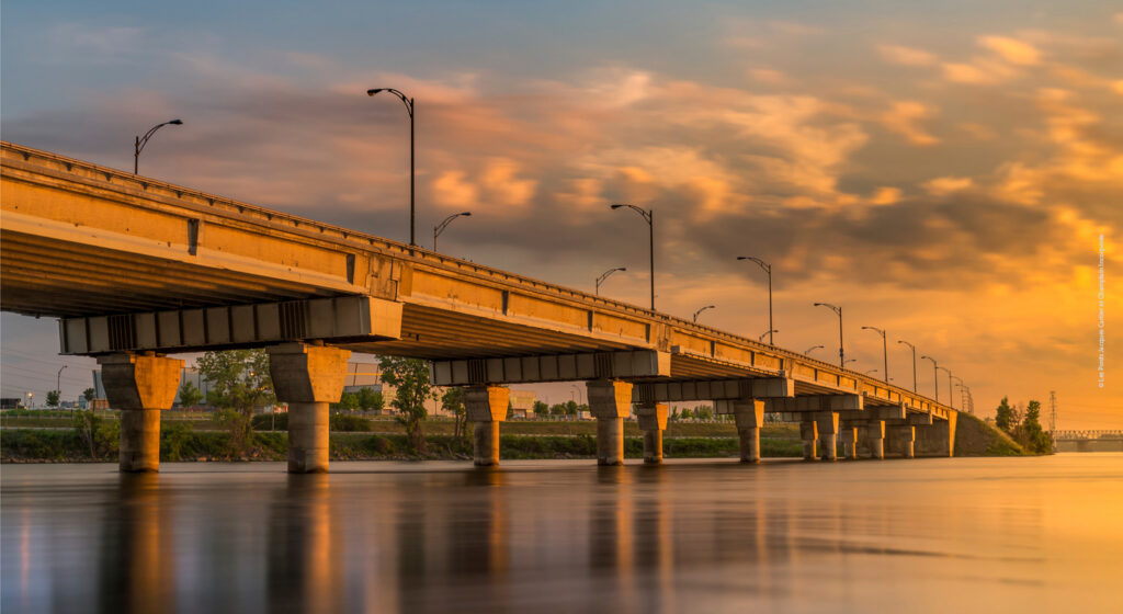 A bridge over a river at sunset.