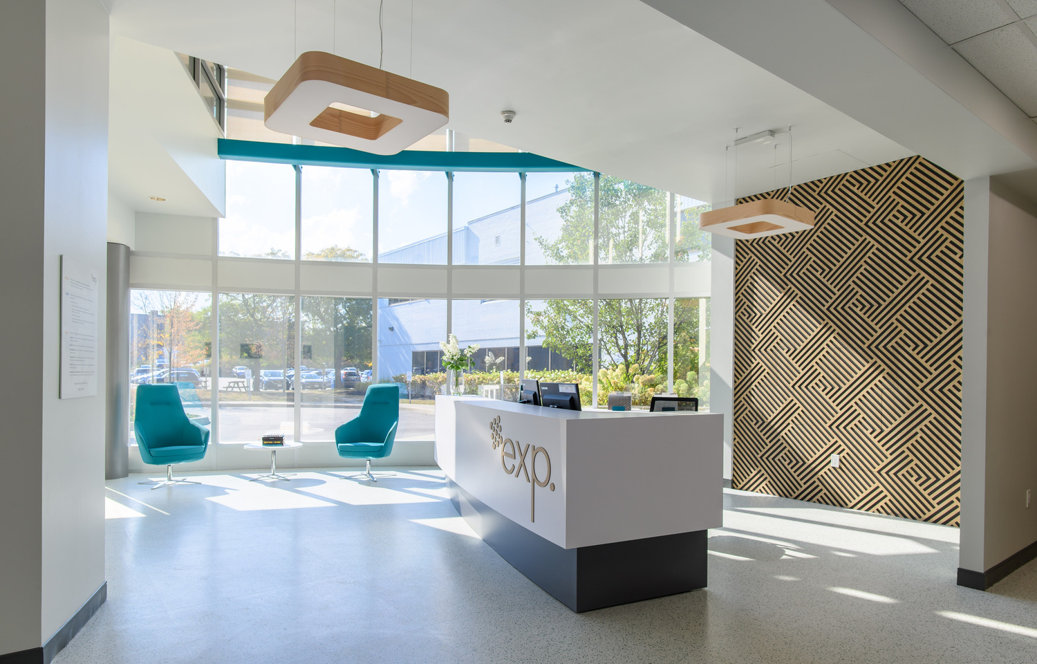 Modern office reception with a white desk labeled 