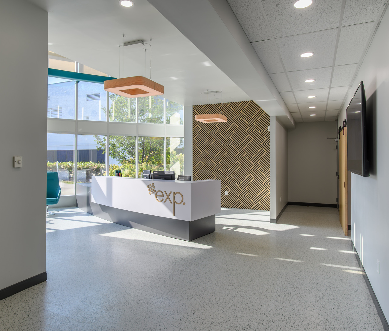 Modern office reception area with a front desk featuring the 