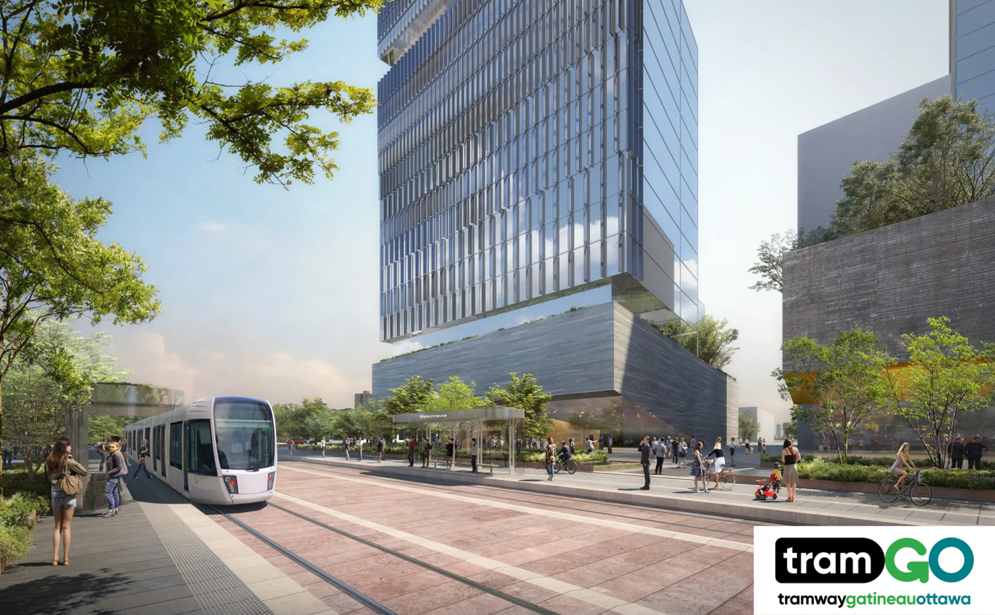 Modern tram passing through a tree-lined urban area with people walking nearby and a tall glass building in the background. "Tram GO" logo is in the bottom right corner.