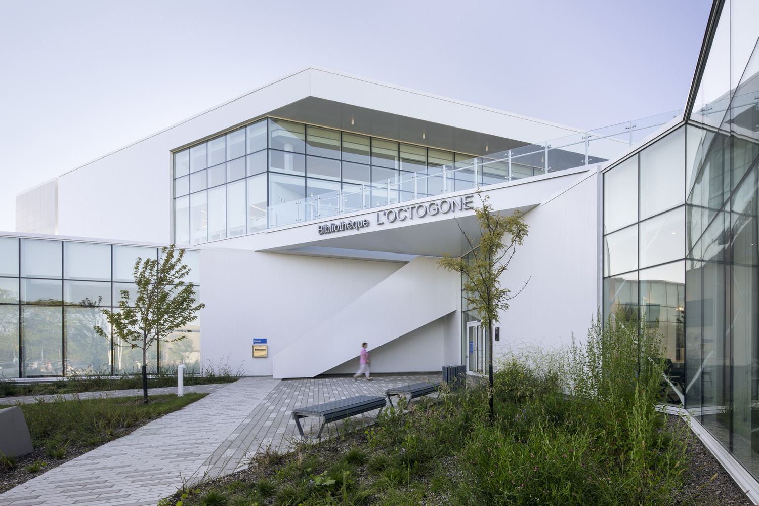 Modern library building with glass facades and an angled entrance labeled 